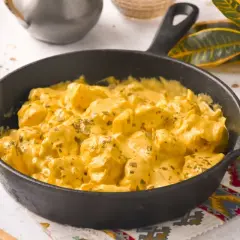 Sabroso pollo al curry con leche de coco, servido en sartén de hierro fundido.