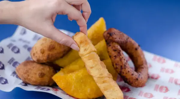 Mano toma un tequeño, un bocado delicioso que nos recuerda de donde son los tequeños, junto a empanadas y chorizo.