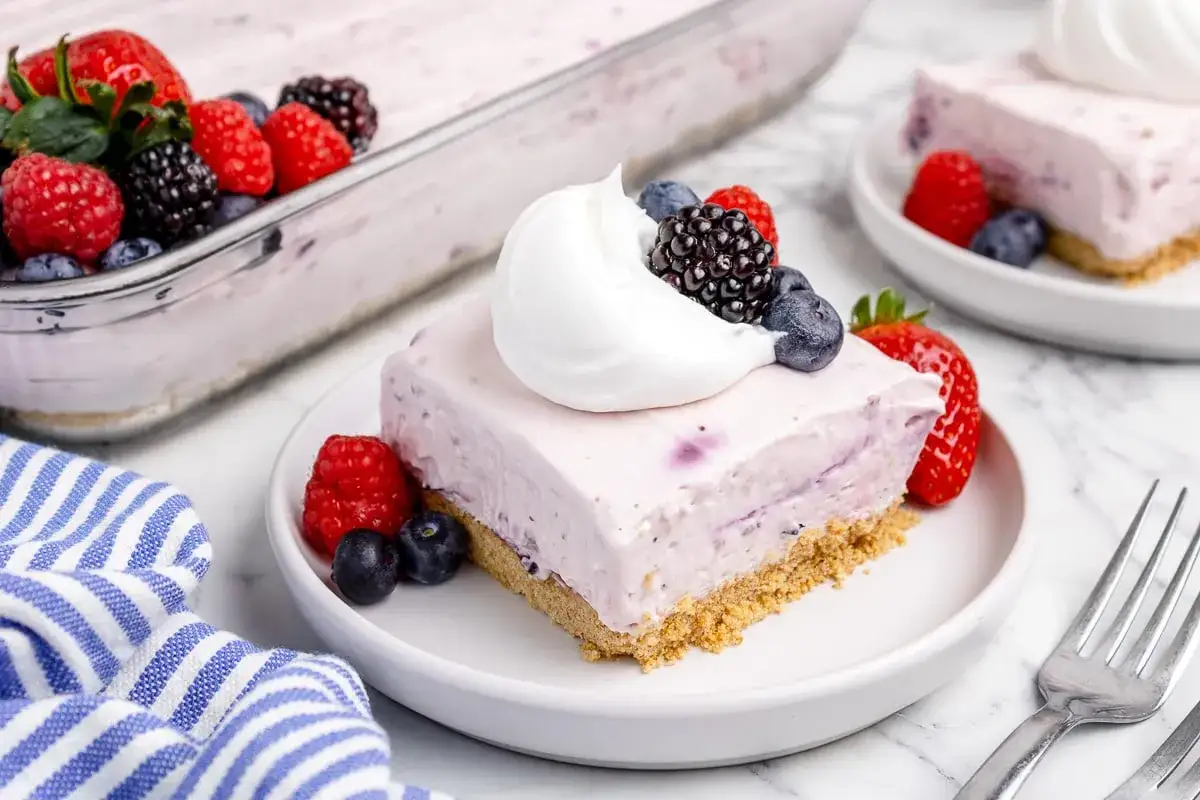 Deliciosa tarta de queso sin horno con frutos rojos y nata montada. Un postre fresco y f&aacute;cil.